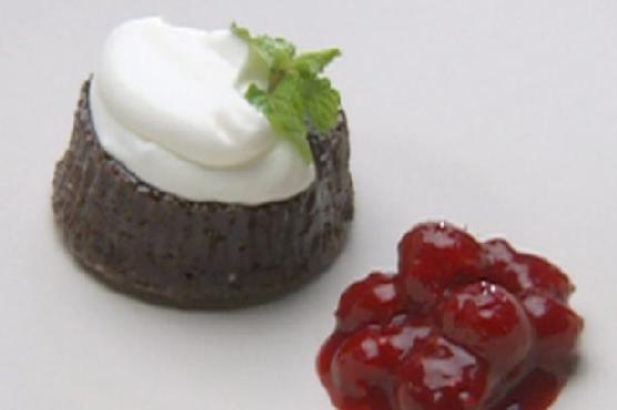 Warm Chocolate Gateaux Topped with Sour Cream Quenelle and Raspberry Sauce